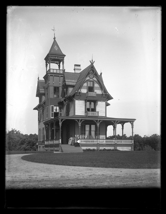 Marriott C. Morris, [Front view of Avocado with two women sitting on the porch, Sea Girt, NJ], ca. 1900.